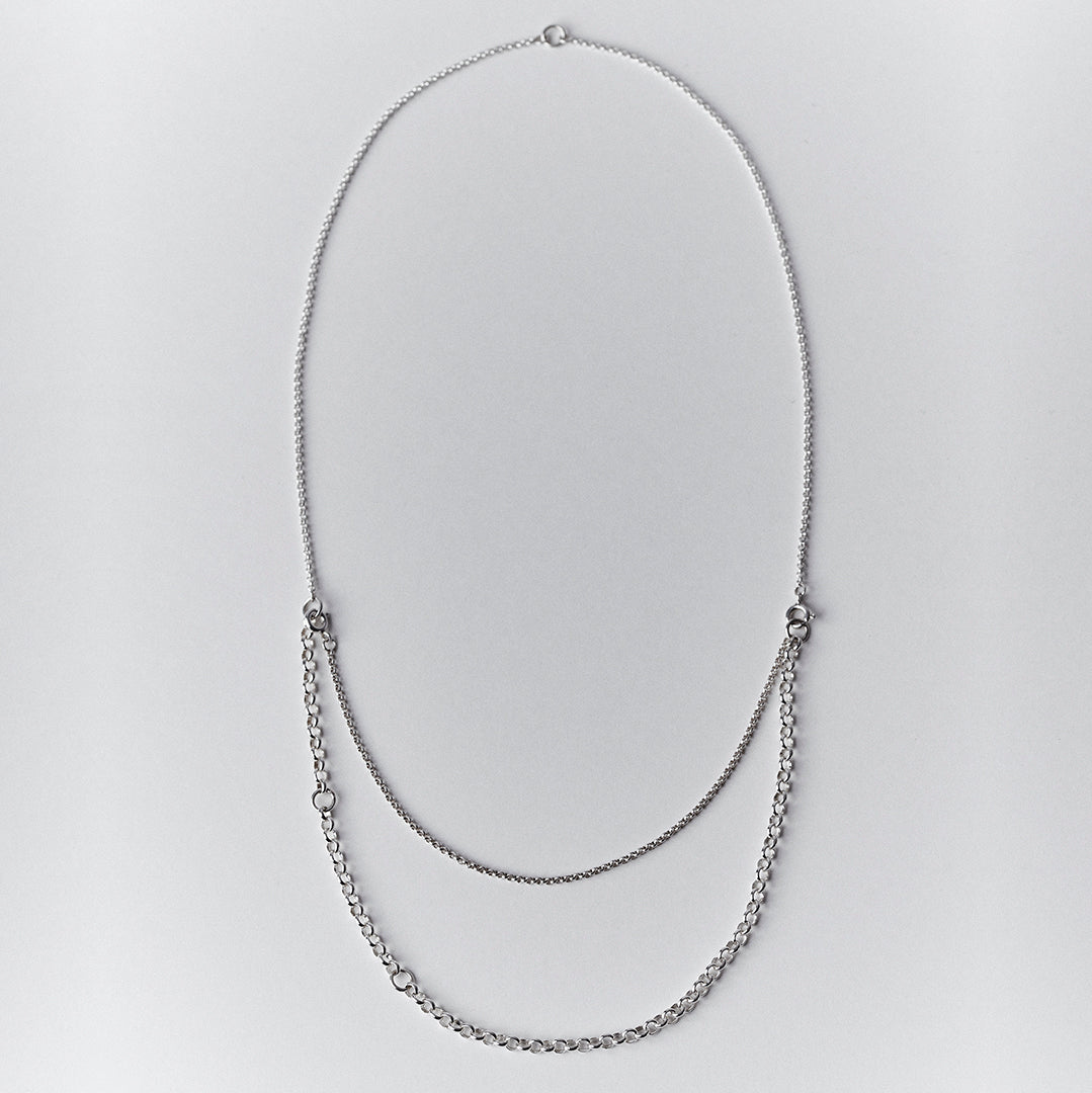An adjustable silver necklace with a double layered chain.