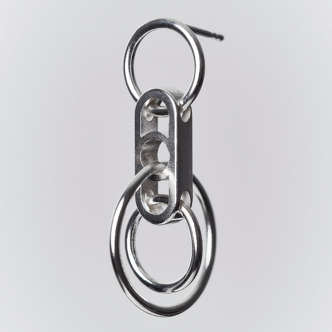 A silver earring with interconnected hanging rings.