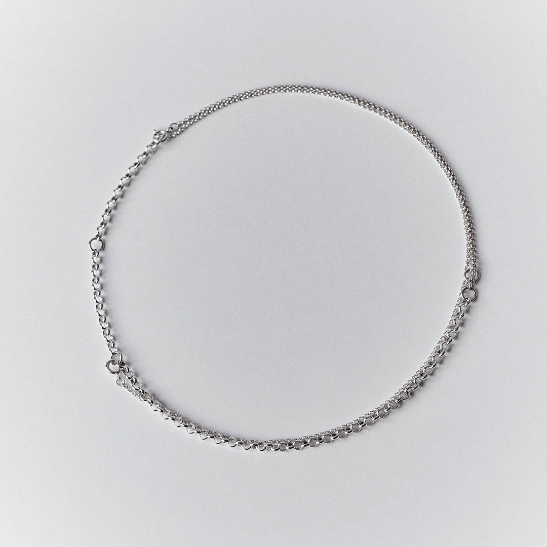 An adjustable silver choker necklace with a double layered chain.