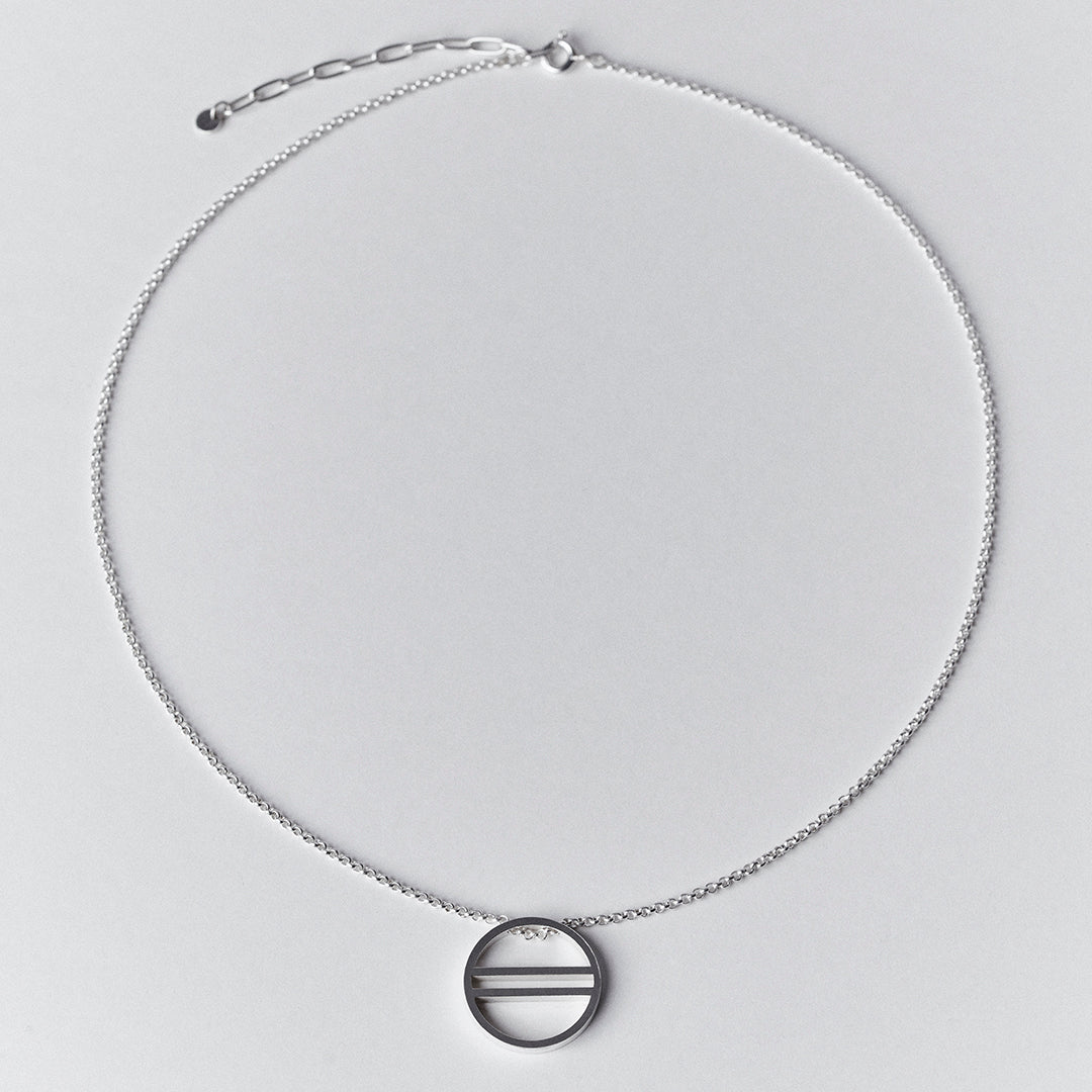 A silver necklace with an equality symbol pendant. 