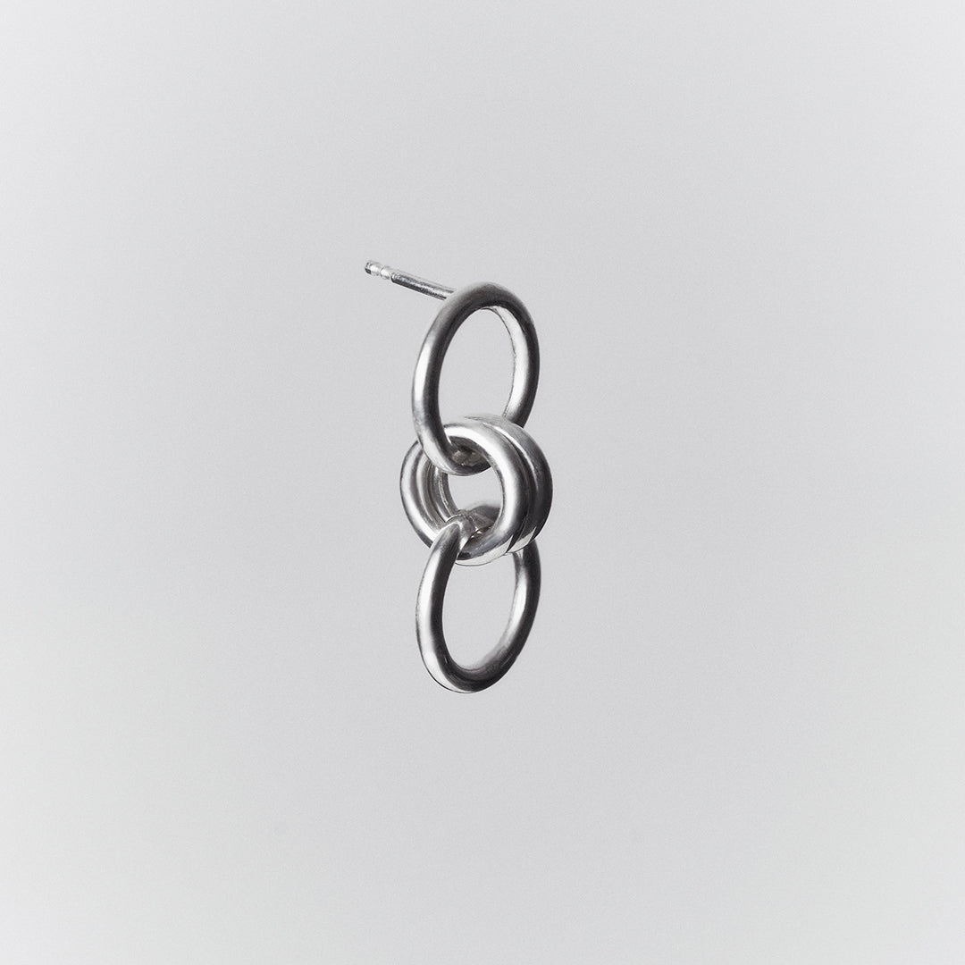 bold silver earring with a double ring loop.